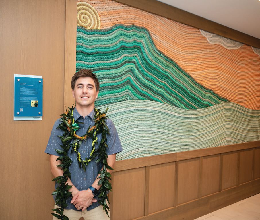 Renowned artist and marine biologist Ethan Estess at the resort entrance in front of his sustainable mural, “Coming Home” PHOTO COURTESY OF OUTRIGGER HOTELS AND RESORTS