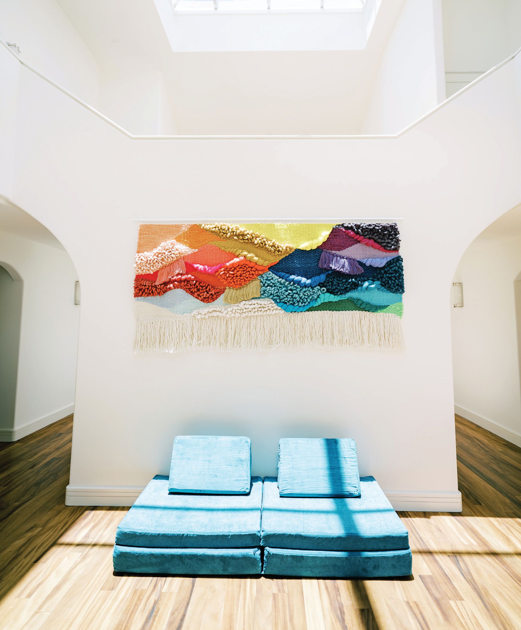 A custom art piece by Australian Maryanne Moodie (maryannemoodie.com) commands the entryway. PHOTOGRAPHED BY MEGAN MOURA