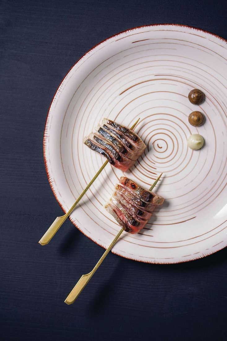 Dry-aged kampachi belly is grilled on the binchotan and serves as a vessel for miso. PHOTO BY MICHELLE MISHINA