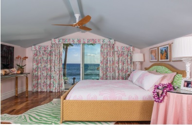 The primary bedroom has a lime zebra rug and upholstered headboard. The bed is covered in fabric depicting the Cymbidium orchid. PHOTO BY JOE D’ALESSANDRO