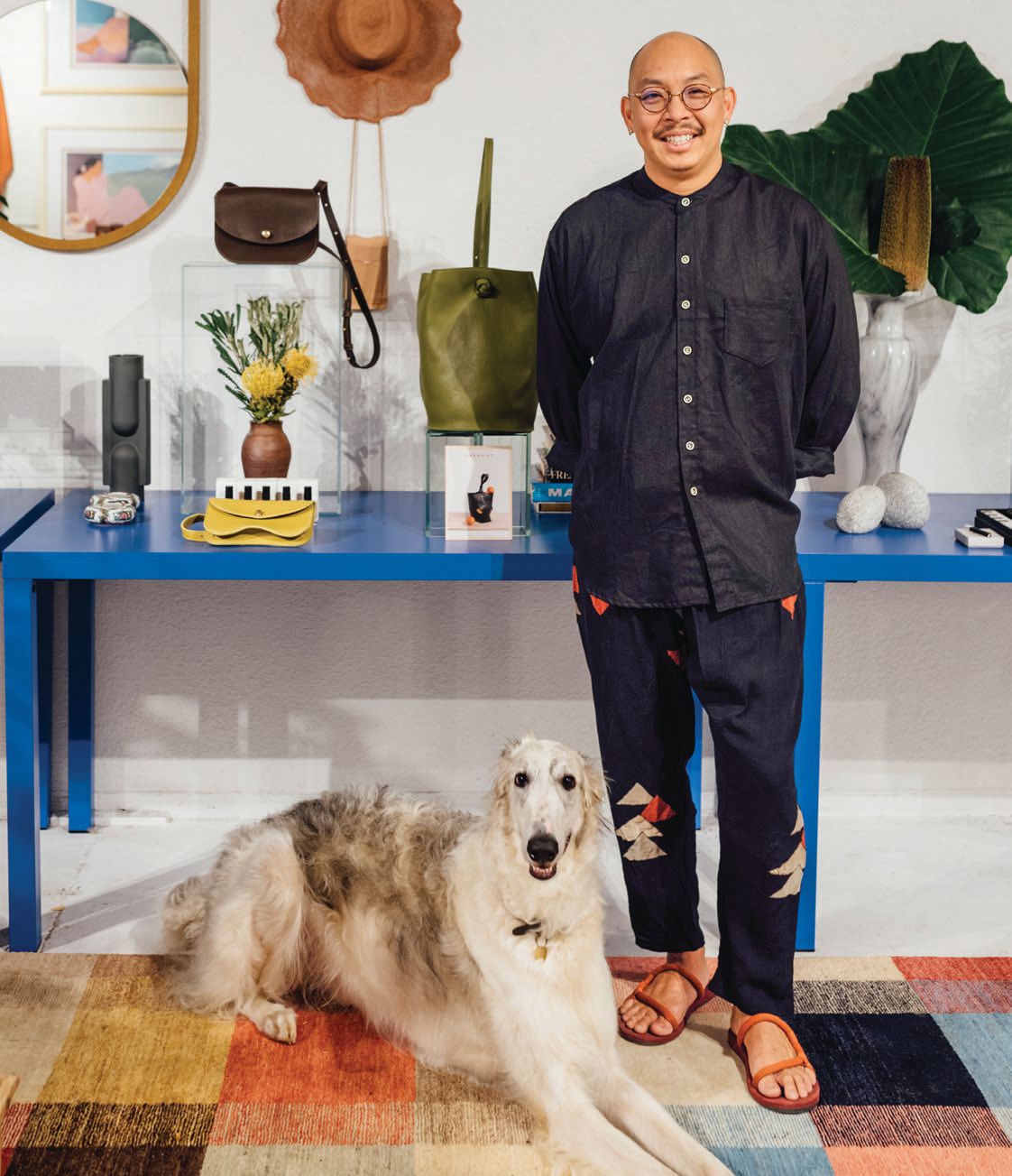 Owner Andrew Mau and shop dog Astro at Island-Boy Shop PHOTO BY IJFKE RIDGLEY